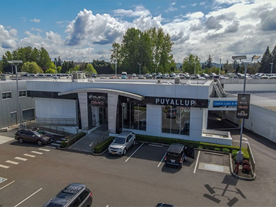 Aerial view of the Puyallup Buick GMC dealership, showcasing the showroom, parking lot, and vehicles.
