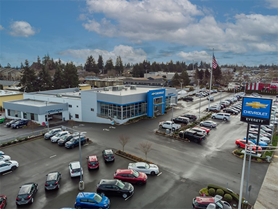 Aerial view of a Chevrolet dealership with a large parking lot full of cars and a sign that reads Chevrolet Everett.