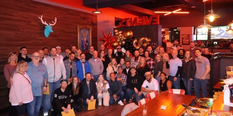 Harnish Auto Family employees gathered for a team celebration and networking event, showcasing the dealership's collaborative workplace culture.